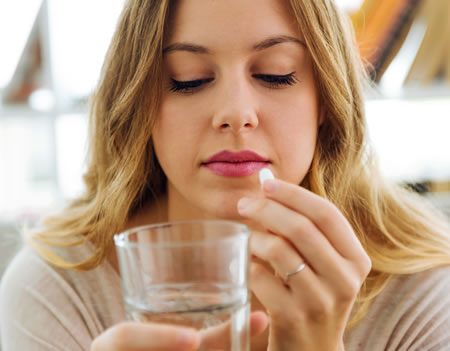 depressed woman taking drugs